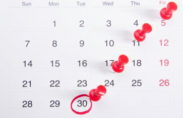 a-calendar-with-red-push-buttons-pinned-to-it.jpg a calendar with red push buttons pinned to it